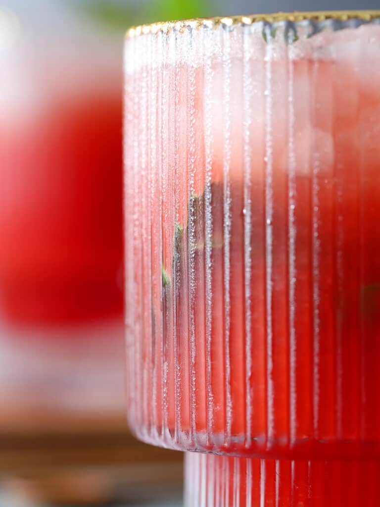 Close up of a frosted glass filled with red liquid.